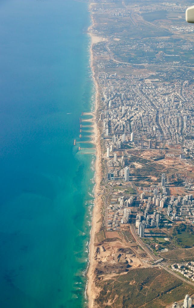 Stunning aerial photograph capturing a coastal cityline with expansive ocean view, embodying travel and adventure.